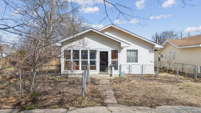 bungalow-style house with a sunroom, a gate, and fence