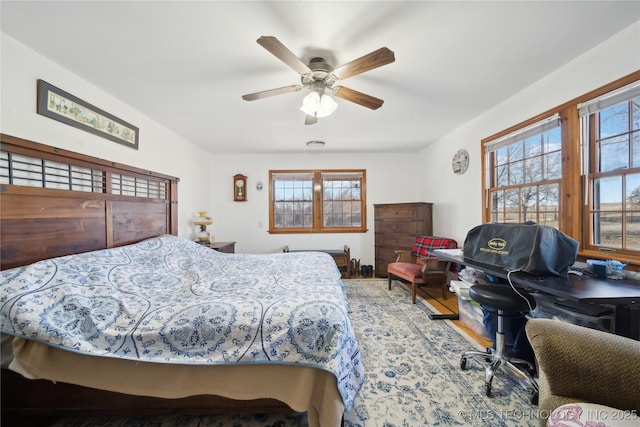 bedroom with ceiling fan and wood finished floors