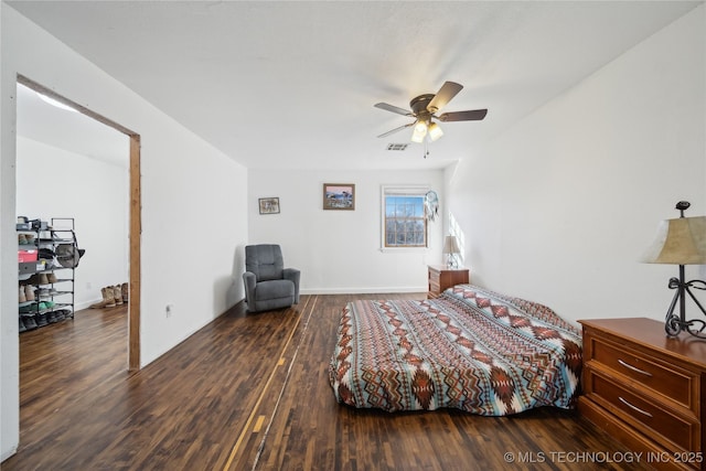 unfurnished bedroom with visible vents, ceiling fan, baseboards, and wood finished floors