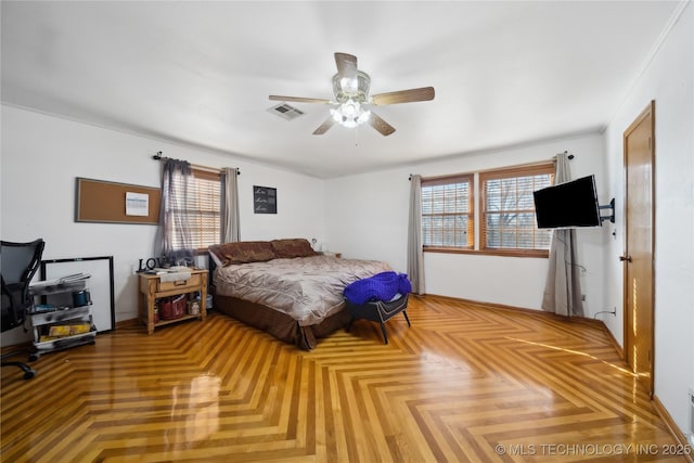 bedroom with visible vents, ceiling fan, and multiple windows