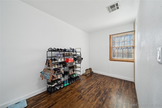 misc room featuring visible vents, wood finished floors, and baseboards