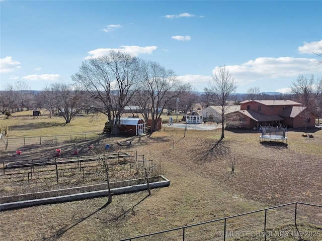 view of yard featuring fence and an outdoor structure