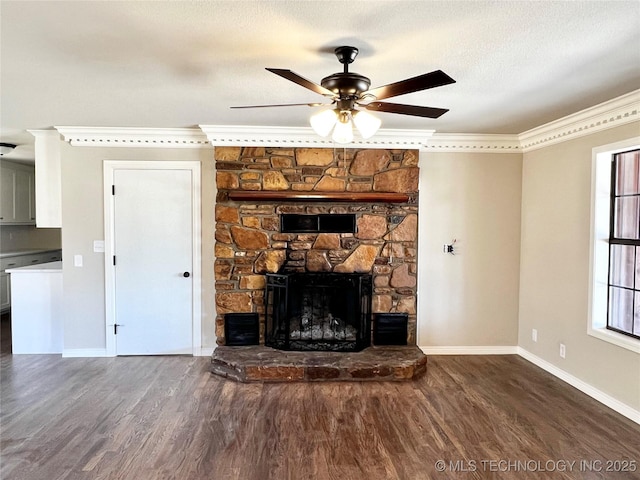 unfurnished living room with a stone fireplace, wood finished floors, and crown molding