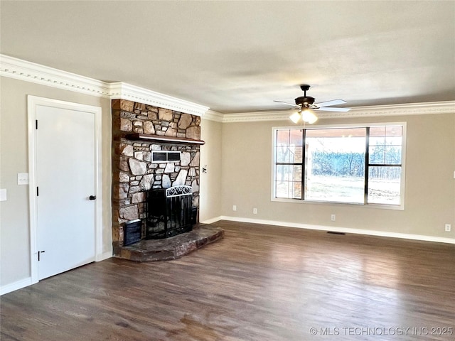 unfurnished living room with ceiling fan, baseboards, ornamental molding, a stone fireplace, and wood finished floors