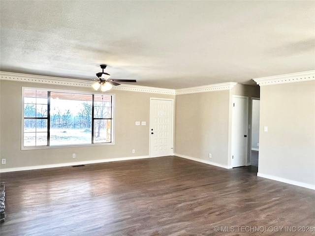 empty room with visible vents, ornamental molding, a ceiling fan, baseboards, and dark wood-style flooring