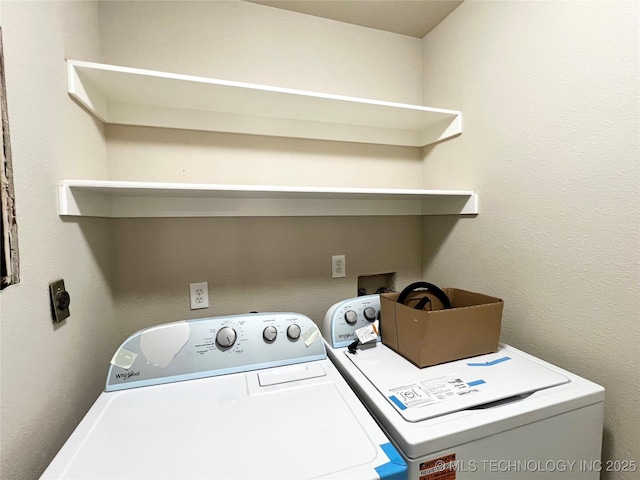 laundry room with washer and dryer and laundry area