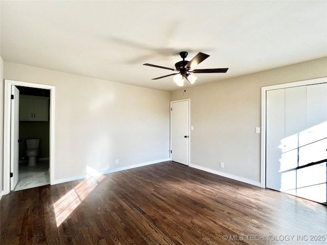 unfurnished room featuring ceiling fan, baseboards, and dark wood-style floors