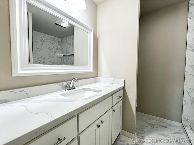 bathroom with vanity, baseboards, and marble finish floor