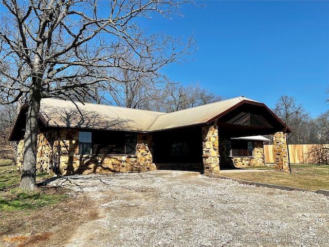 view of front of home featuring stone siding and driveway