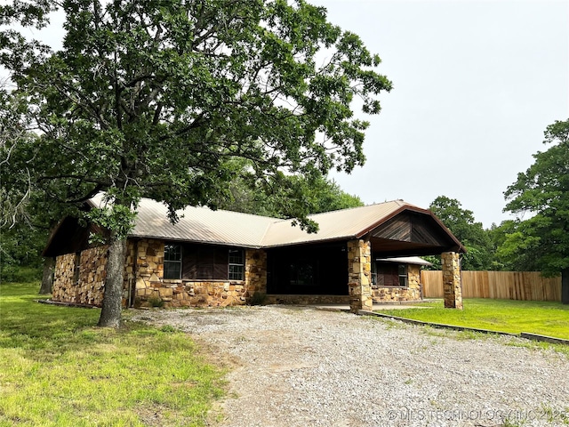 16306 N Javine Hill Rd, Skiatook, OK 74070 - view of front of house with stone siding, gravel driveway, and metal roof
