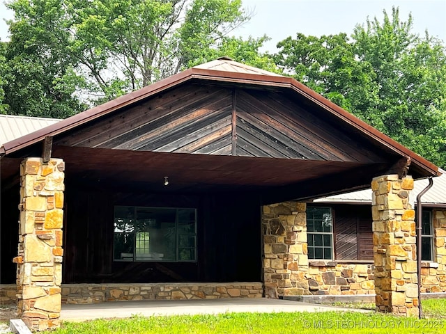 16306 N Javine Hill Rd, Skiatook, OK 74070 - view of front of house with stone siding, metal roof, and a standing seam roof