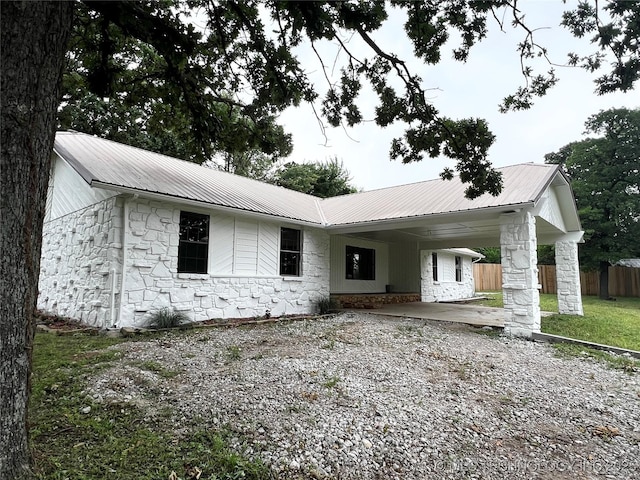 16306 N Javine Hill Rd, Skiatook, OK 74070 - single story home with stone siding, metal roof, a carport, and driveway