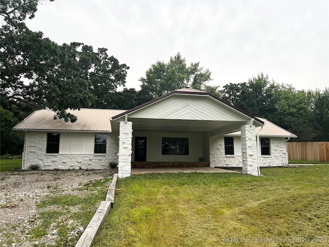 16306 N Javine Hill Rd, Skiatook, OK 74070 - rear view of house with stone siding, metal roof, and a patio area