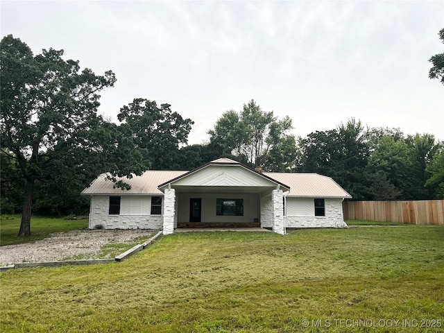 16306 N Javine Hill Rd, Skiatook, OK 74070 - view of front facade with stone siding, metal roof, and view of wooded area