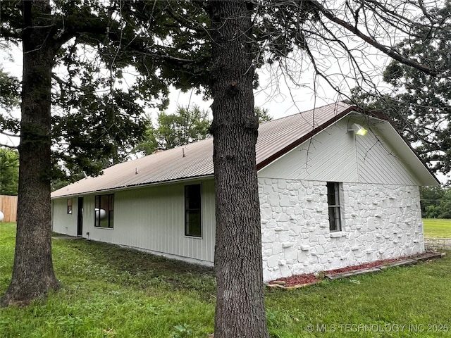 16306 N Javine Hill Rd, Skiatook, OK 74070 - view of home's exterior featuring stone siding, a yard, and metal roof