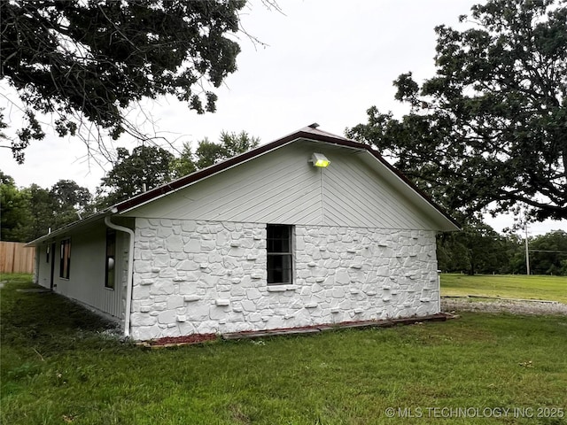 16306 N Javine Hill Rd, Skiatook, OK 74070 - view of home's exterior with stone siding and a lawn