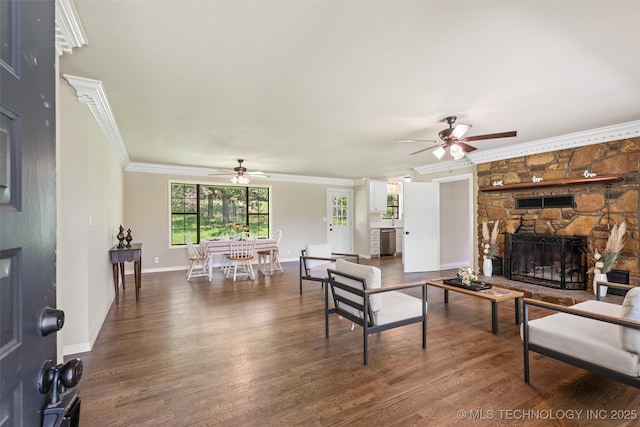 16306 N Javine Hill Rd, Skiatook, OK 74070 - living area with ceiling fan, ornamental molding, wood finished floors, and a stone fireplace
