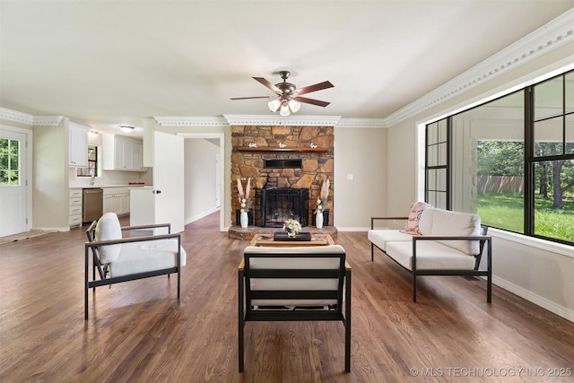 16306 N Javine Hill Rd, Skiatook, OK 74070 - living room featuring ceiling fan, crown molding, wood finished floors, and a stone fireplace