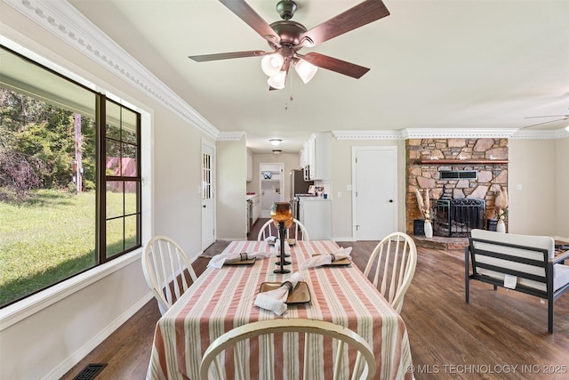 16306 N Javine Hill Rd, Skiatook, OK 74070 - dining space featuring a ceiling fan, dark wood-style floors, plenty of natural light, ornamental molding, and a fireplace