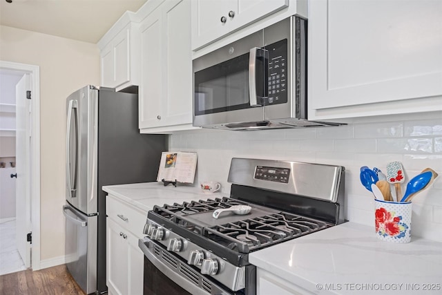 16306 N Javine Hill Rd, Skiatook, OK 74070 - kitchen featuring stainless steel appliances, white cabinets, light stone countertops, and backsplash