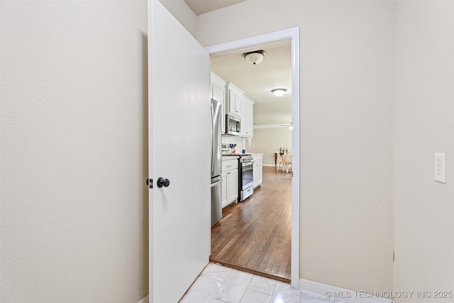 16306 N Javine Hill Rd, Skiatook, OK 74070 - corridor featuring light marble finish flooring and baseboards