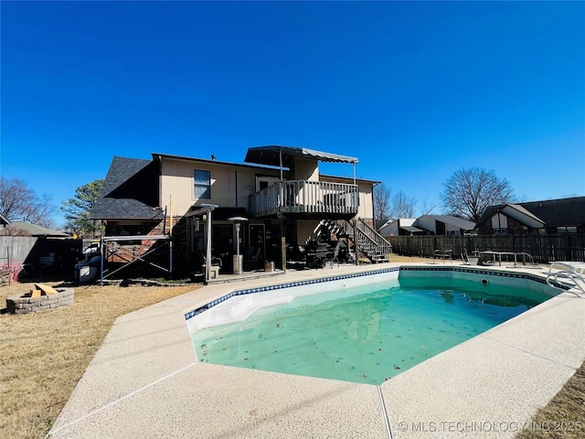 view of pool with a deck, a patio, fence, stairway, and a fenced in pool