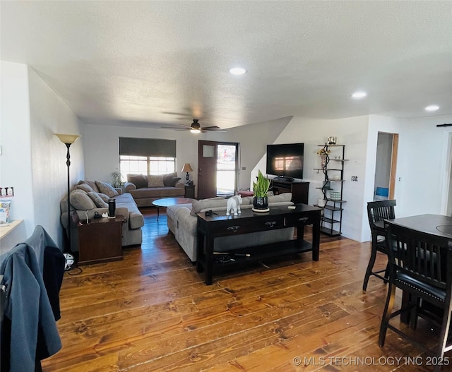 living room with a ceiling fan, recessed lighting, a textured ceiling, and hardwood / wood-style flooring