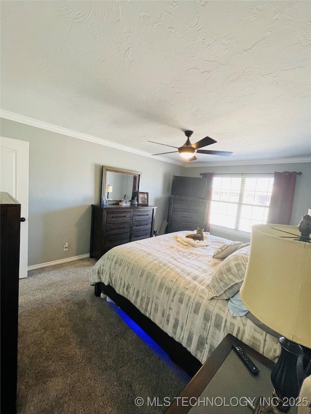 carpeted bedroom with a textured ceiling, baseboards, a ceiling fan, and crown molding