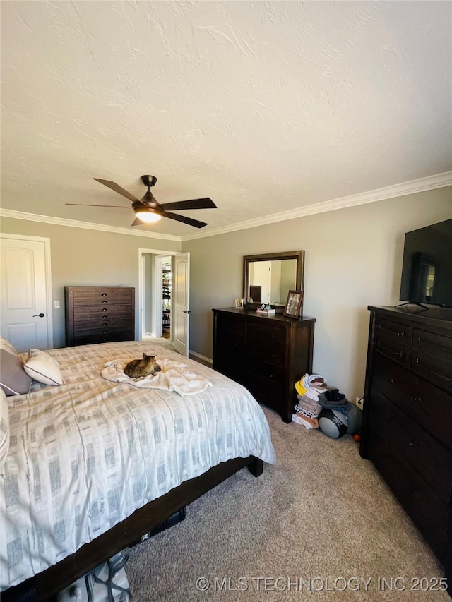 carpeted bedroom with a textured ceiling, ceiling fan, and ornamental molding