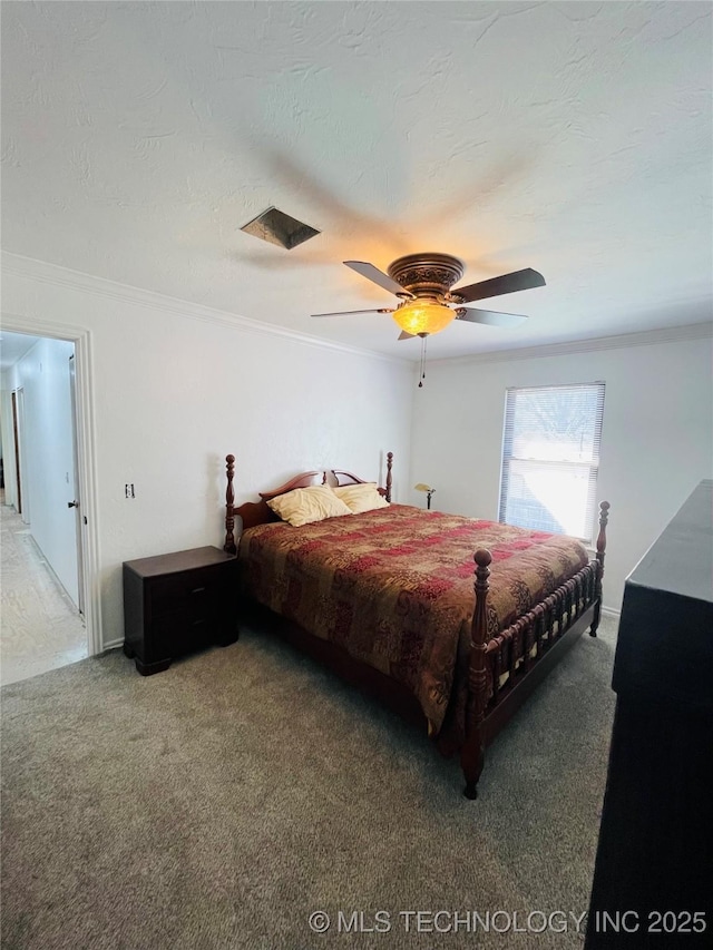 bedroom featuring carpet floors, a textured ceiling, a ceiling fan, and crown molding