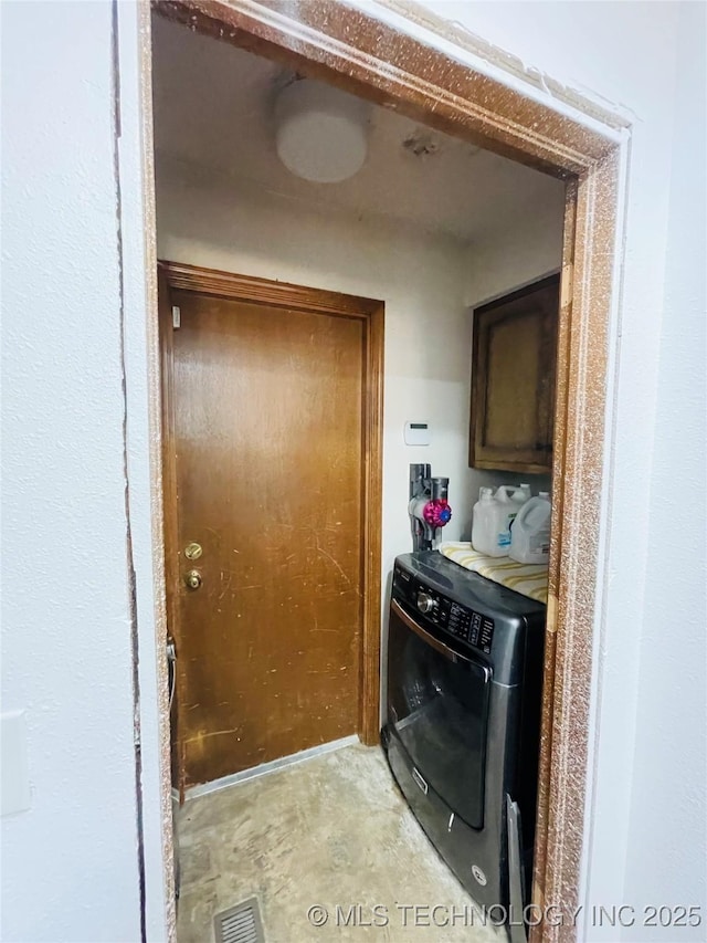 laundry room with visible vents, washer / clothes dryer, and cabinet space