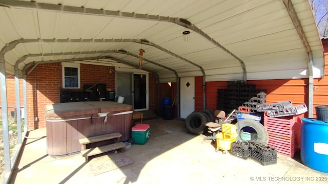 view of patio / terrace featuring a carport and a hot tub