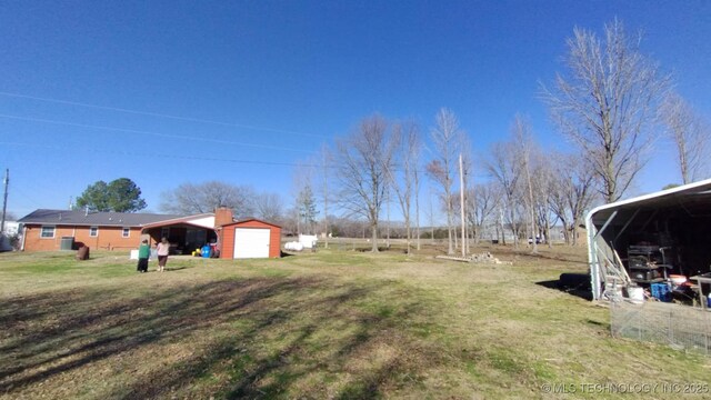 103877 US Highway 59 N, Sallisaw, OK 74955 - view of green lawn featuring an outbuilding and a garage