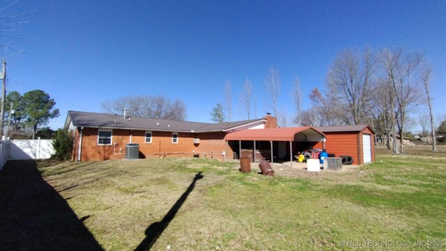 103877 US Highway 59 N, Sallisaw, OK 74955 - back of house featuring cooling unit, an outbuilding, a chimney, and a storage shed
