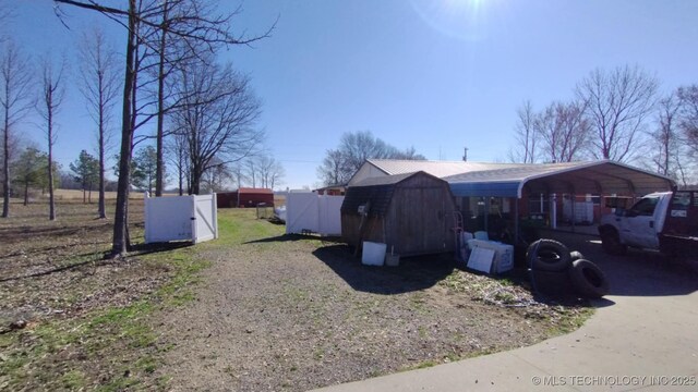 103877 US Highway 59 N, Sallisaw, OK 74955 - view of yard with a storage unit, fence, an outdoor structure, a detached carport, and driveway
