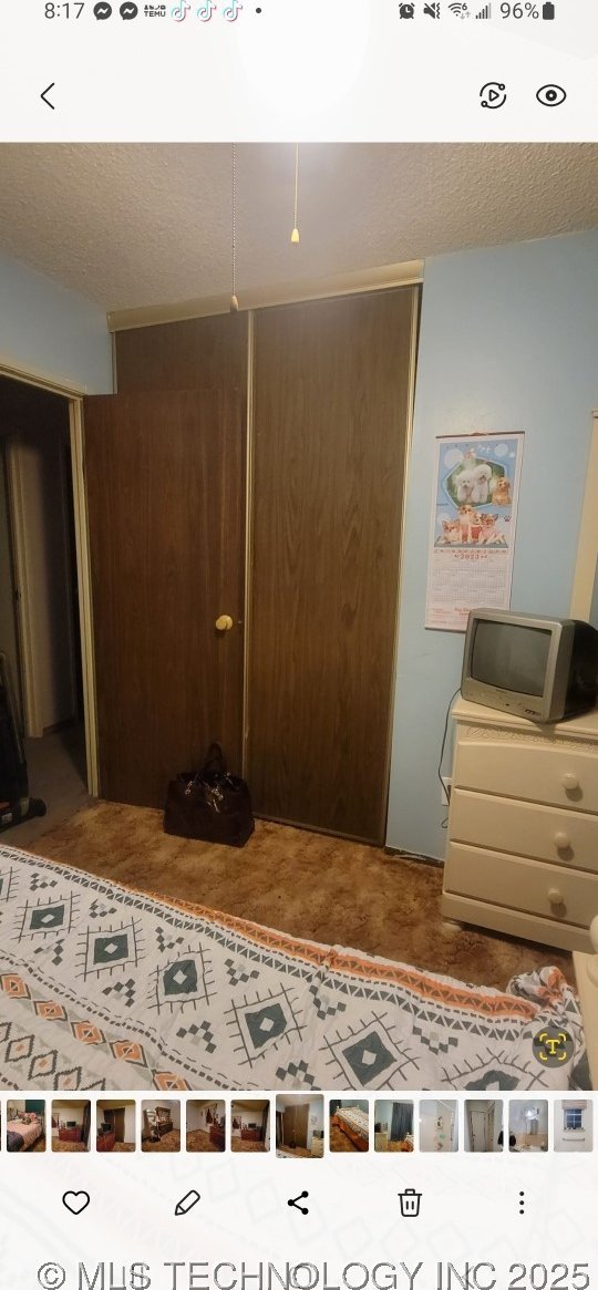 103877 US Highway 59 N, Sallisaw, OK 74955 - bedroom featuring a closet and a textured ceiling