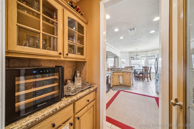 bar featuring wine cooler, crown molding, visible vents, backsplash, and appliances with stainless steel finishes