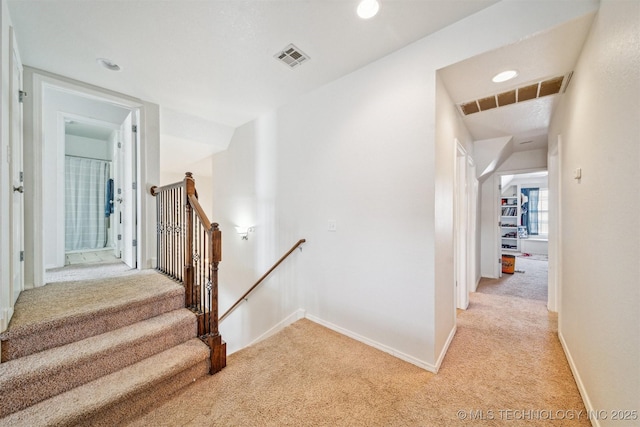 stairs featuring baseboards, visible vents, carpet flooring, and recessed lighting