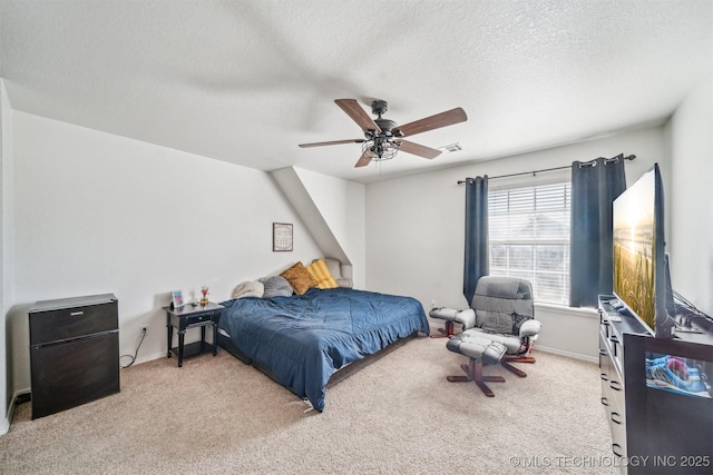 bedroom with ceiling fan, a textured ceiling, carpet flooring, visible vents, and baseboards