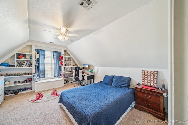 carpeted bedroom with ceiling fan, visible vents, vaulted ceiling, and a textured ceiling