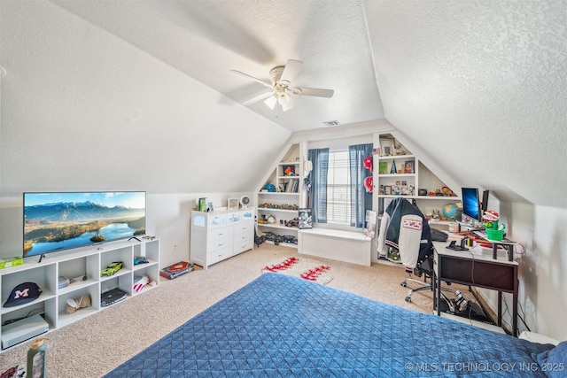 carpeted bedroom with lofted ceiling, a ceiling fan, visible vents, and a textured ceiling