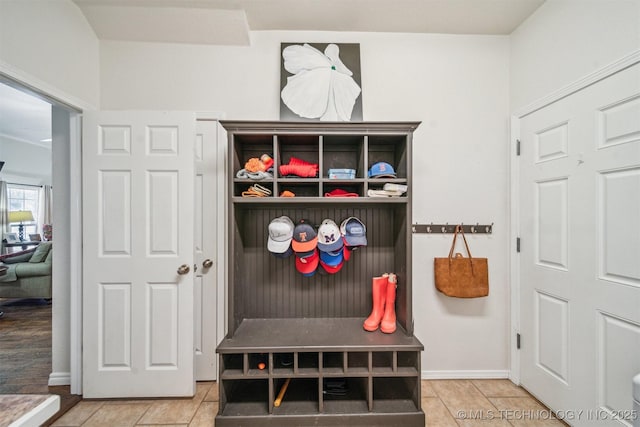 mudroom with baseboards and tile patterned floors