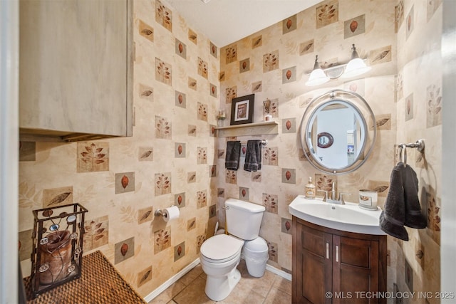 bathroom with baseboards, vanity, toilet, and tile patterned floors