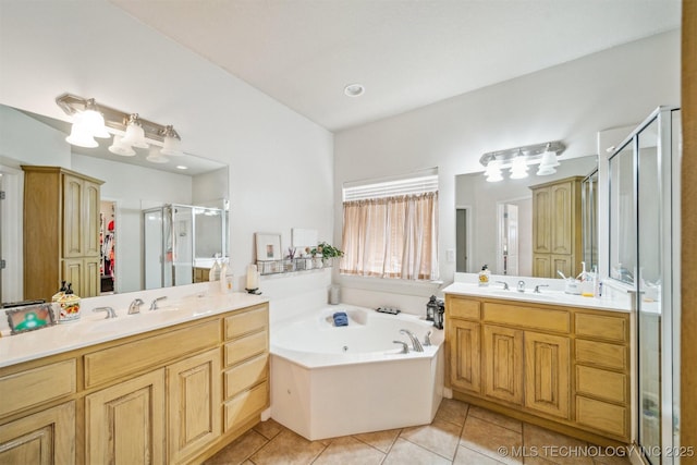 full bathroom with a garden tub, tile patterned flooring, two vanities, a sink, and a shower stall