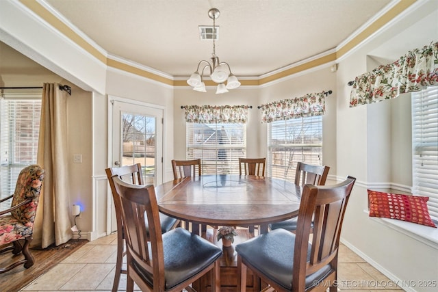 dining space featuring a chandelier, light tile patterned floors, visible vents, baseboards, and ornamental molding