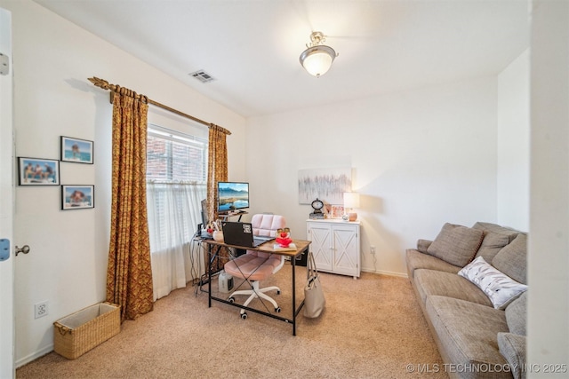 carpeted office with visible vents and baseboards