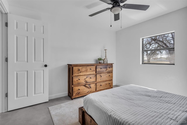 bedroom with finished concrete flooring, baseboards, and a ceiling fan