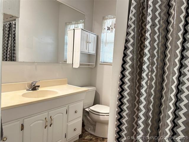 bathroom featuring toilet and vanity