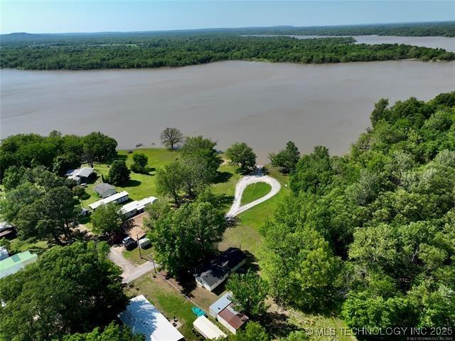 aerial view featuring a forest view and a water view