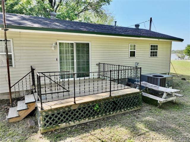 back of house featuring central AC unit and a wooden deck